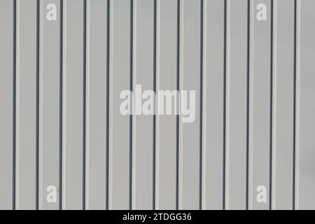 Closeup, abstract detail section of white, smooth, wooden fence boards with painted, shiny surface. Stock Photo