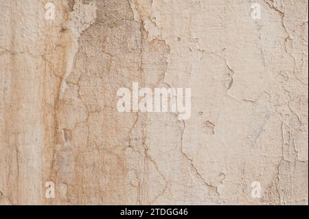 Abstract, detail, pattern of textured, white, peeling paint layers on an old stone exterior wall of a building in Jerusalem, Israel. Stock Photo