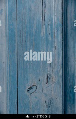 Closeup, abstract detail section of blue, painted wooden fence boards with painted, weathered, textured, grainy surface. Stock Photo