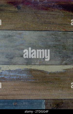 Closeup, abstract detail of a section of wooden fence boards with weathered, faded and colorful, smooth surface Stock Photo