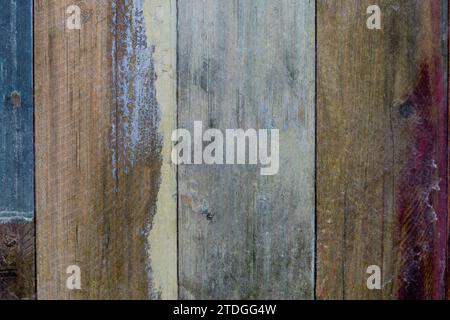 Closeup, abstract detail of a section of wooden fence boards with weathered, faded and colorful, smooth surface Stock Photo