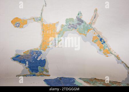 Abstract, detail, pattern of multi-colored peeling paint layers behind a white surface on an old stone interior wall of a building in Jerusalem, Israe Stock Photo