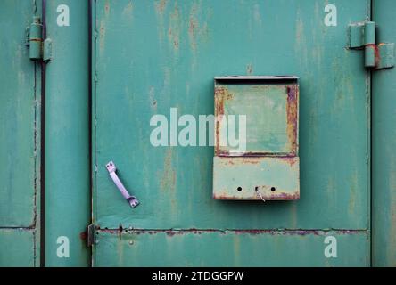 Old, painted in green mailbox in retro style. Stock Photo