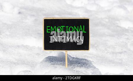 Emotional intimacy symbol. Concept words Emotional intimacy on beautiful black chalk blackboard. Beautiful white snow background. Psychology emotional Stock Photo