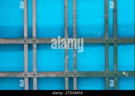 Abstract rendering of metal bars, lines and blue plastic material covering a door. Stock Photo