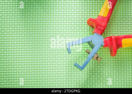 Insulated wire strippers on green background electricity concept Stock Photo