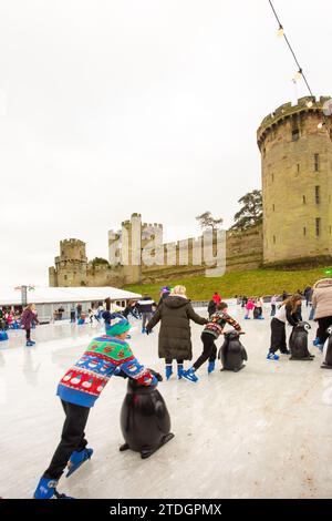 People skating on the temporary mobile artificial ice rink as part of the festive Christmas market at Warwick Castle Warwickshire England UK Stock Photo