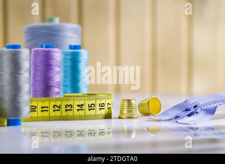 Arrangement of sewing utensils on a white table Stock Photo