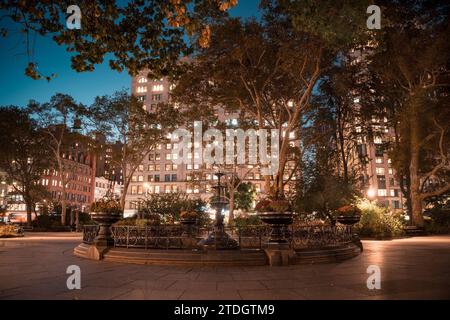 Madison Square Park in midtown Manhattan, New York City with fountain seen at night Stock Photo