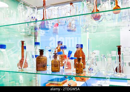 Laboratory glass dishes, bottles, jars and flasks in store Stock Photo