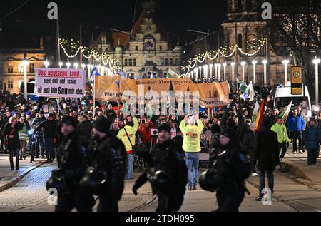 Dresden, Germany. 18th Dec, 2023. Participants in a demonstration of the right-wing extremist movement Pegida walk across the Augustus Bridge. Credit: Robert Michael/dpa/Alamy Live News Stock Photo