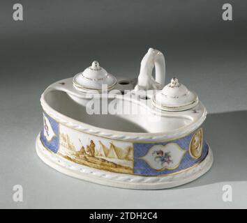 Inkstel, painted with a landscape with figures in tents, manufacture Oud-Loosdrecht, c. 1778 - c. 1782 Porcelain ink set. Oval with ear on one side. In the two large round openings closed at the top for an ink jar and a sand spreader, both with lid and four holes for pens. Along the top and bottom edge a braided ribbon motif in relief. Painted at the front with a landscape with figures at tents in Sepia in a rectangular field, which interrupts a frieze of light blue grilles. Three cartouches on the sides have been saved on the sides, the middle one of which is a medallion with a cracked men's Stock Photo