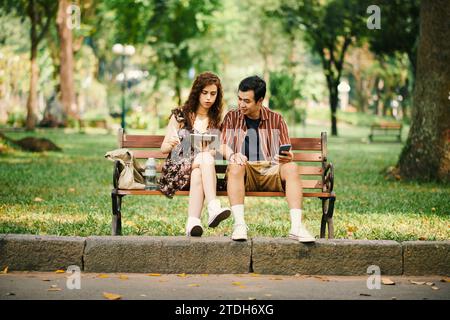 Young woman showing boyfriend her drawing on tablet computer Stock Photo
