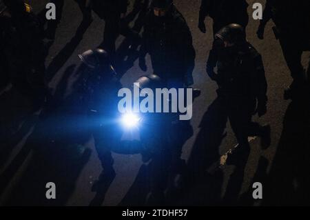 Dresden, Germany. 18th Dec, 2023. Police officers accompany a demonstration by the right-wing extremist movement Pegida, shining a flashlight. Credit: Robert Michael/dpa/Alamy Live News Stock Photo