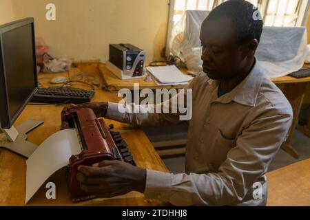 A blind person during typing work on a special braille typewriter. Stock Photo