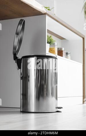 Opened trash bin in interior of light kitchen Stock Photo
