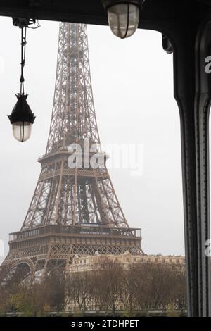 The Eiffel Tower under the Bir Hakeim bridge in the rain in Paris - France Stock Photo