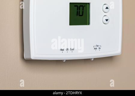 Thermostat for home furnace and air conditioner. Utility bill savings, energy cost and conservation concept Stock Photo