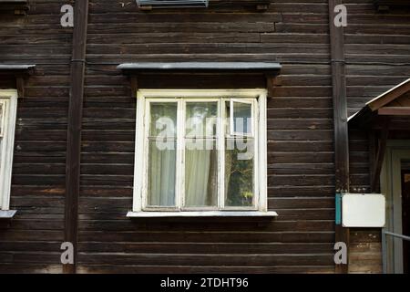 Window in old house made of boards. House of 20s. Old architecture. Wooden window frame. Stock Photo