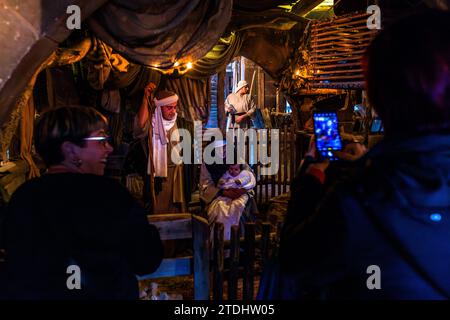 Gtar Grotto. Mary and Joseph with baby Jesus in the Bethlehem village of Għajnsielem on Gozo surrounded by stables with donkeys and sheep and marveled at by visitors in Mġarr, Malta Stock Photo