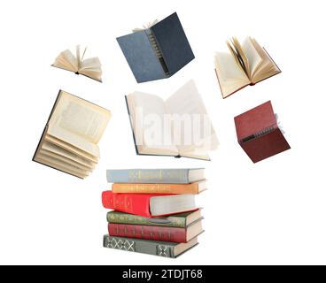 Books flying over stack on white background Stock Photo