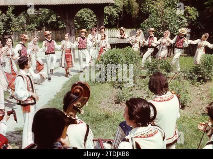 Socialist Republic of Romania, approx. 1979. A folk assemble wearing beautiful national costumes performing a traditional dance. Stock Photo