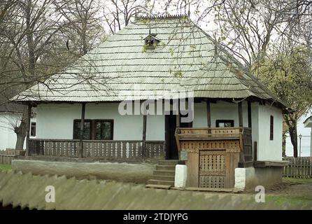 The Village Museum, Bucharest, Romania, approx. 2000. Traditional house from Prahova County with wooden porch and roof and beautifully ornate entrance to the cellar. Stock Photo