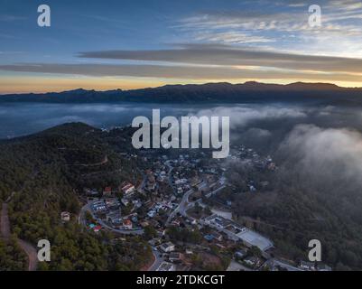 Aerial view of the village and urbanizations of Rellinars under Sant Llorenç del Munt on a foggy sunrise. Vallès Occidental Barcelona, Catalonia Spain Stock Photo