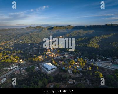 Aerial view of the village and urbanizations of Rellinars under Sant Llorenç del Munt on a foggy sunrise. Vallès Occidental Barcelona, Catalonia Spain Stock Photo