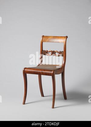 Chair with Swans, Anonymous, 1830 Chair from a set of ten chairs and four arm chairs of partly solid and partly glued mahogany on elm core. Loose covered seats. The square hind legs areas backwards. Nine chairs and an armchair have square, slightly rounded at the front, front legs; The rest has round articulated front legs. The stretched S-shaped backs have a sculpted intermediate rule with a palmet flanked by two swans bending back with the necks. The flat volute -shaped armrests run high in the back. Northern NetherlandsNetherlands wood (plant material). mahogany (wood). elm (wood). textile Stock Photo