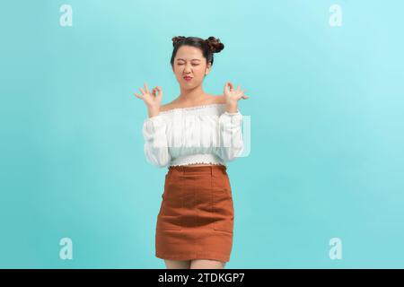 Young Asian woman making hand gesture with surprise face Stock Photo