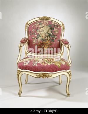 Arm chair covered with tapisserie with flower bouquets, I. Gourdin, c. 1770 Arm chair, part of an ameublement, made of white with gold painted beech wood and covered on a loose window with tapisserie, that bouquets, bound by ribbons together, shows on a red dammed soil. The front legs, by-line, upper sill and styles of the back window wear stabbed leaf and floral motifs. The armrests with cushions end in volutes; The S-shaped legs covered over-corner ends in an Acanthus leaf. Marked: I. Gourdin. See: BK-16655-A/C-G. maker: Francemaker: Parismaker: Parisdesigner: Francedesigner: France wood (pl Stock Photo