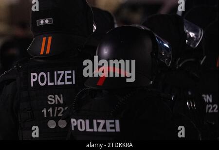 Dresden, Germany. 18th Dec, 2023. Police officers accompany a demonstration by the right-wing extremist movement Pegida on Schlossplatz. Credit: Robert Michael/dpa/Alamy Live News Stock Photo