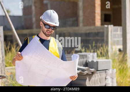 Professional construction worker engineer male. Real estate house project builder. Smart architect man standing work in construction site. Stock Photo
