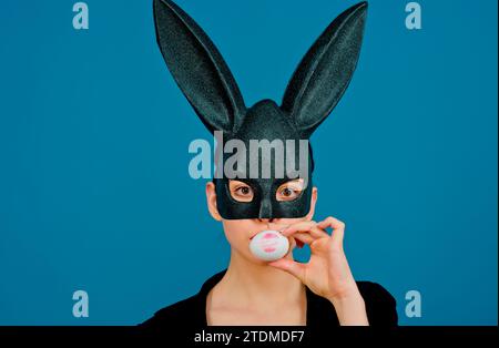 Lipstick kiss print on easter egg. Happy easter. Girl with lace bunny ears. Bunny woman. Easter bunny woman, rabbit and girl. Stock Photo