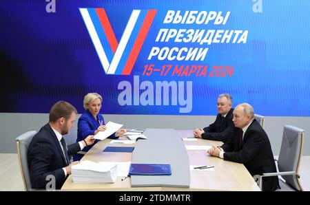 Moscow, Russia. 18 December, 2023. Russian President Vladimir Putin, right, submits his documents to be registered as a candidate in the upcoming 2024 Russian presidential election at the Central Election Commission, December 18, 2023 in Moscow, Russia. Credit: Russian Presidency/Kremlin Pool/Alamy Live News Stock Photo