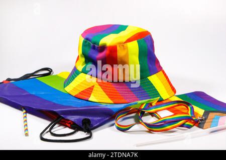 gay pride  rainbow hat  lanyard  bag & flag isolated on white studio background rainbow stripes lgbtq Stock Photo