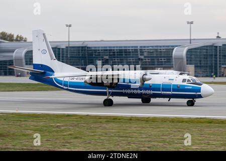 Ukrainian airline's Motor Sich Antonov An-24RV regional aircraft slowing down on the runway after landing at Lviv Airport Stock Photo