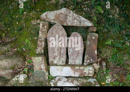 Carved stone monoliths at a Japanese shrine in Wakayama Prefecture in Japan. Stock Photo