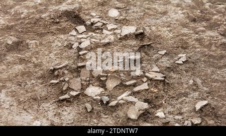 Archaeological excavations, archaeologists work, dig up an ancient clay artifact which is five thousand years old. Background Stock Photo