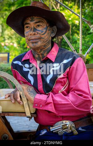 Tattooed man in cowboy hat relaxing at the 2013 Maverick music festival ...