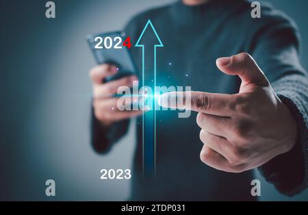 Hand man touch on virtual bar status to change from 2023 to 2024, countdown of merry Christmas and happy new year by technology concept, start new bus Stock Photo
