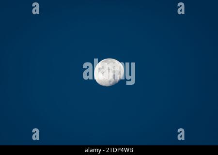 Close up of Big Moon during daytime against clear blue sky Stock Photo