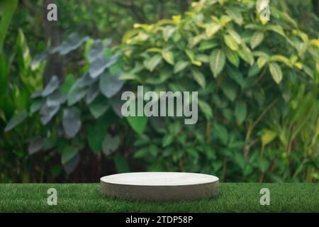 Concrete podium tabletop floor in outdoor tropical garden forest blurred green leaf plant nature background.Natural product placement pedestal stand d Stock Photo