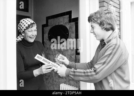 Boy in training jacket at the door of the house with campaign material 'Helps build Haarlem', Haarlem, The Netherlands, 22-04-1978, Whizgle News from the Past, Tailored for the Future. Explore historical narratives, Dutch The Netherlands agency image with a modern perspective, bridging the gap between yesterday's events and tomorrow's insights. A timeless journey shaping the stories that shape our future Stock Photo