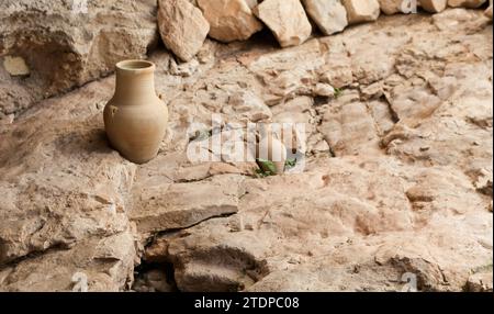 Clay beige round pot on stone background. handmade furniture in rustic style. Still life with ceramic rounded vase for interior design from Israel Stock Photo