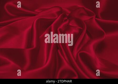 Red silk or satin luxury fabric texture can use as abstract background. Top view Stock Photo