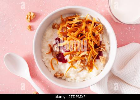 rice pudding with Norwegian brunost traditional brown cheese and raspberry jam Stock Photo