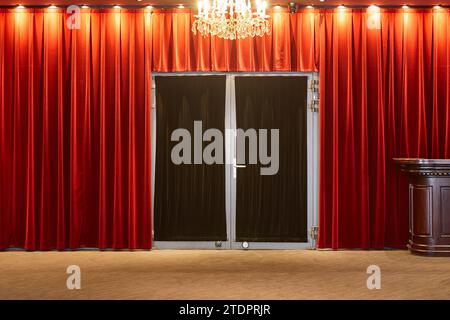 Elegant red velvet curtain. Theater cinema entrance. Entertainment Stock Photo