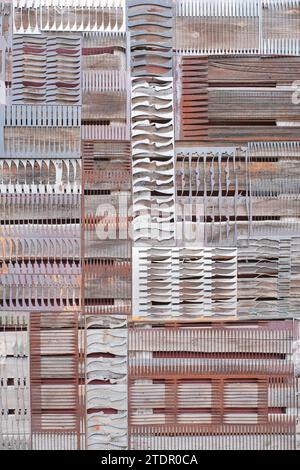Abstract metal background with perforations in shape of various knives Stock Photo